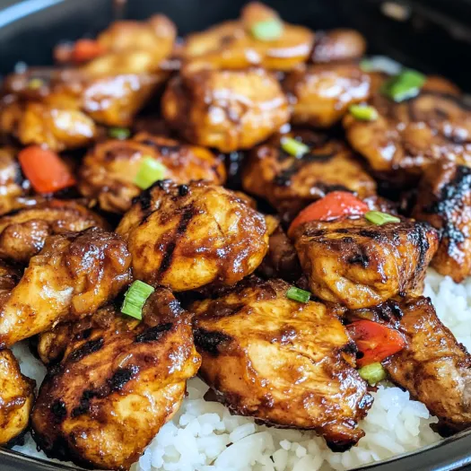 A bowl of chicken with rice and vegetables.