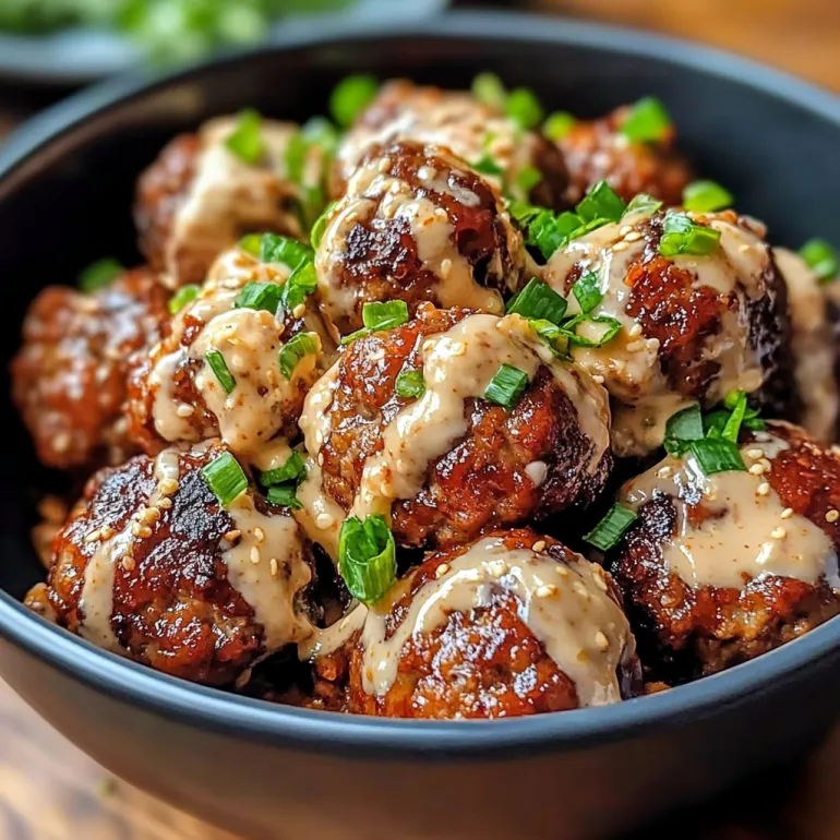 A bowl of meatballs with spicy mayo dip.