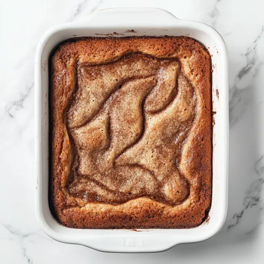 A square piece of gingerbread pudding cake.