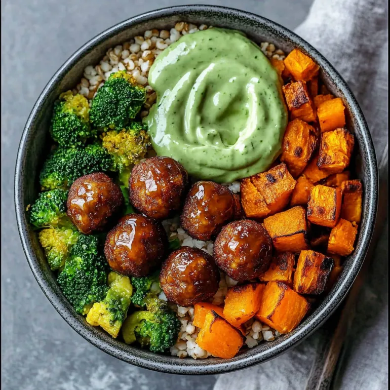 A bowl of meatballs with a green sauce and broccoli.