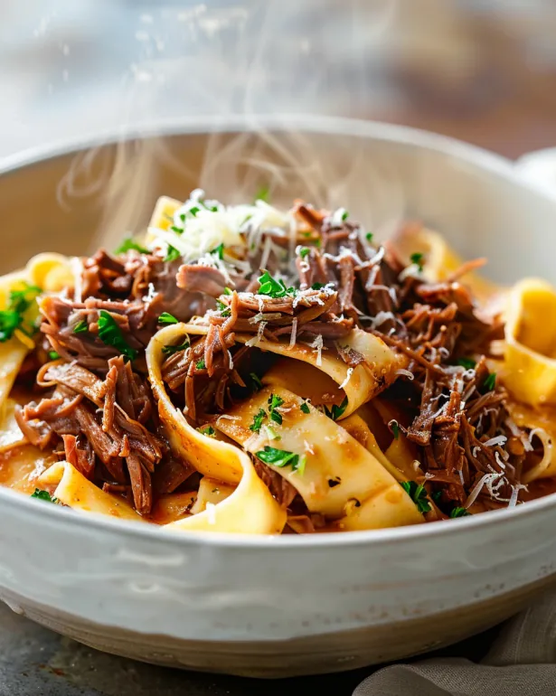 A bowl of beef and pasta.