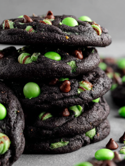 Chocolate chip cookies with green and white toppings.