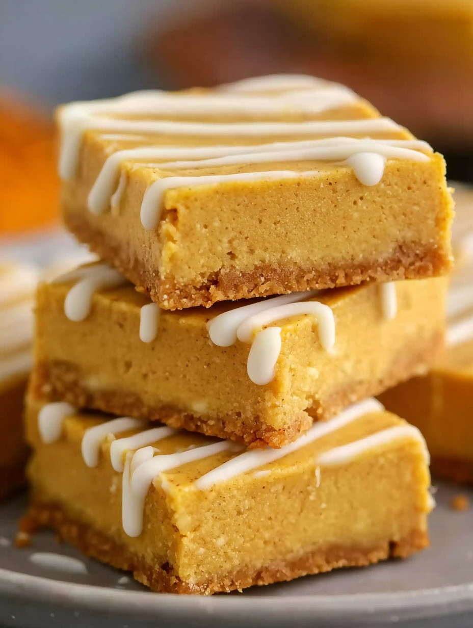 A stack of cake bars with white icing.