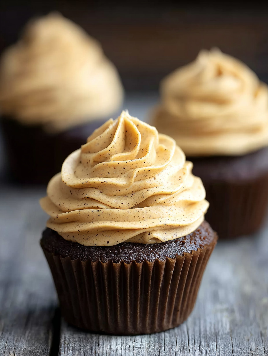 A cupcake with a frosting of caramel and chocolate.