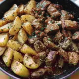 A plate of garlic butter steak and potatoes.