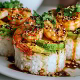 Spicy shrimp sushi stacks on a plate.